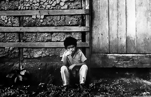 Boy sitting on front stoop of home (Furlow, Sept. 1978)